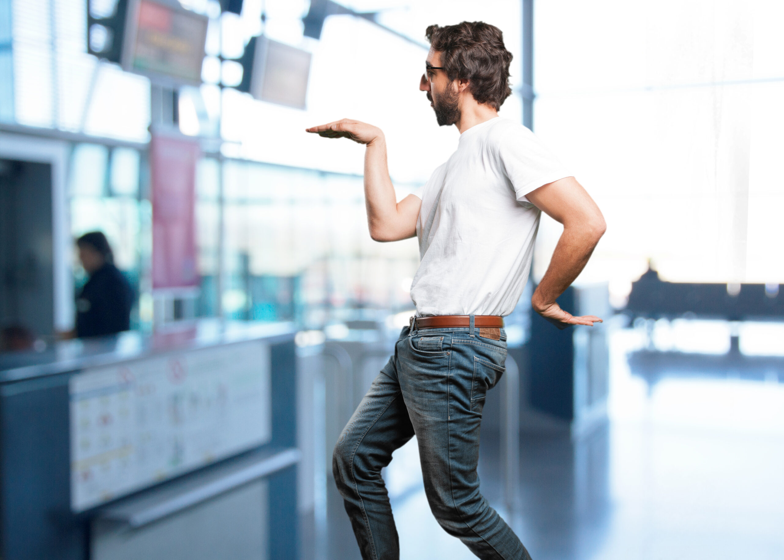 A man making a funny pose at an airport