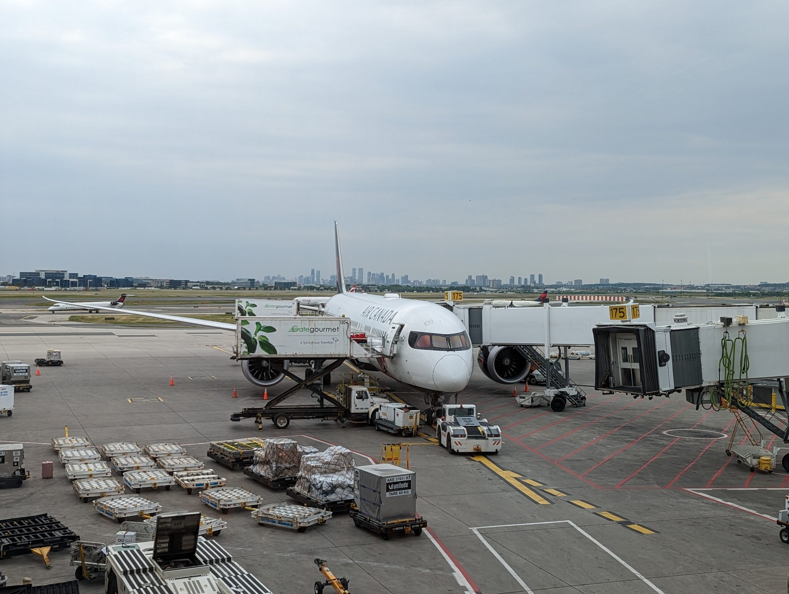 An Air Canada 787 bound for Seoul on the ground with an airbridge.