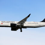 An Air Canada A220 in the air.