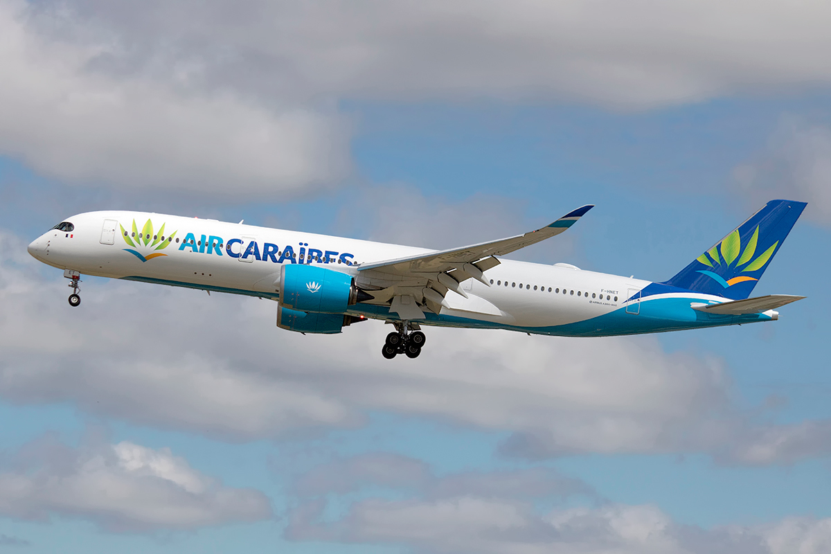 An Air Caraibes aircraft taking off with landing gear out.