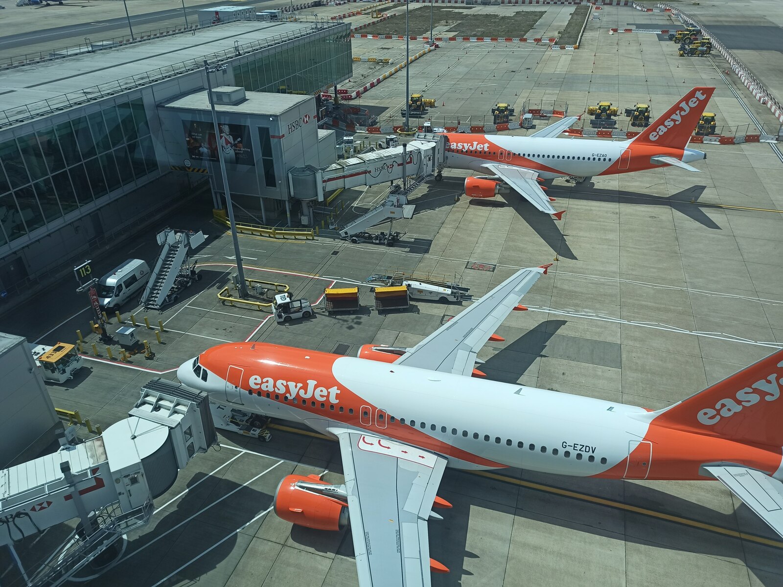 Image shows two easyJet planes waiting on the tarmac at Gatwick Airport