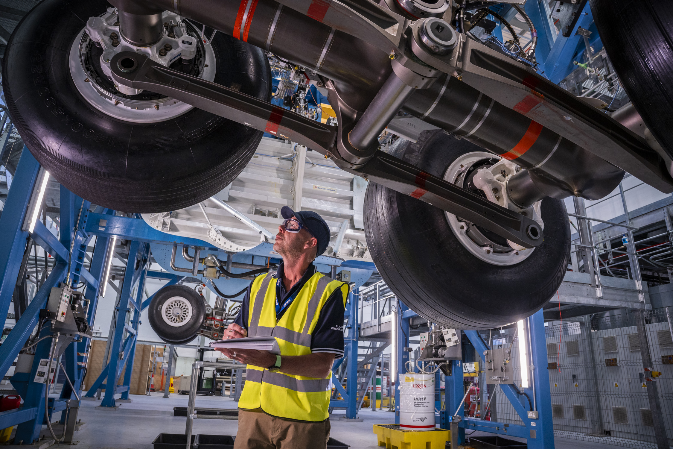 Image shows an engineer under an aircraft inspecting an Airbus landing gear system at the company's Filton site
