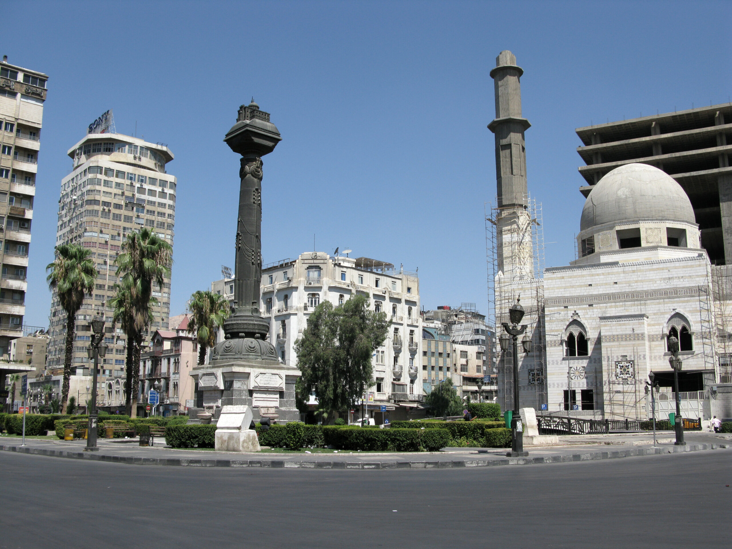 The Town Square of Damascus, with a mosque, monuments and apartment buildings nearby.
