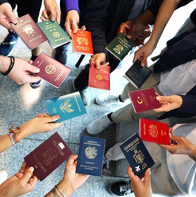 Hands holding passports from different countries, reflecting global passport rankings, aviation trends, and travel diplomacy.