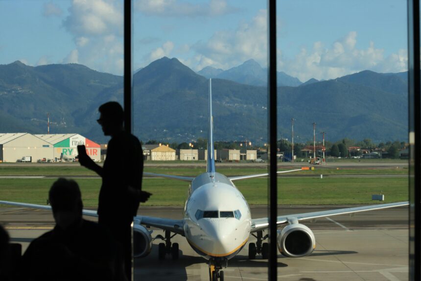 Ryanair flight from Bergamo airport in Italy. Ryanair leveraging network connectivity. There is uncertainty in air travel amid Ryanair's French routes cuts and airfare tax hikes.