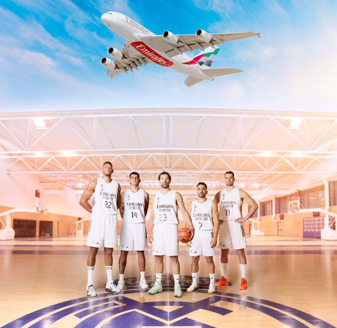 An emirates aircraft and representatives from Real Madrid basketball team in the new jersey with Emirates' "fly better" tagline.