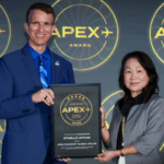 Jessica Lin, STARLUX Airlines Director of Airport Operations, stands beside a man in a blue suit holding a plaque that reads “APEX Five Star Global Airline 2026” at the Long Beach Convention Centre.
