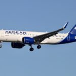 A blue and white Airbus A320 NEO flying for Aegean airlines.