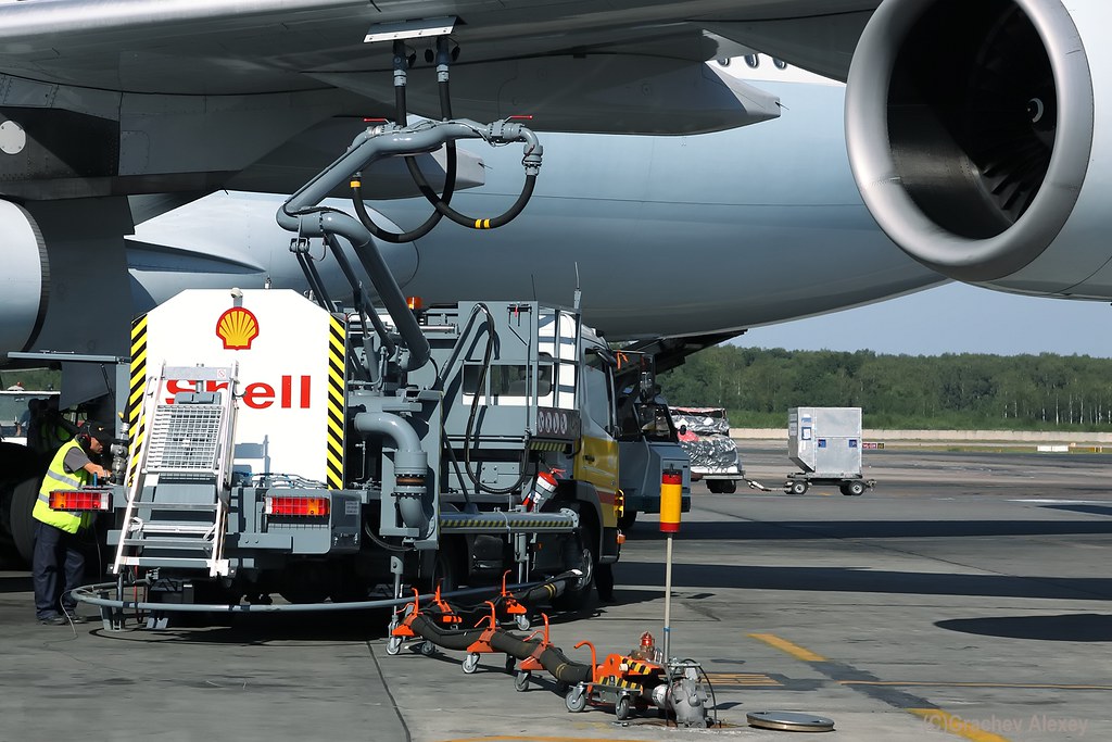 Cathay Pacific Aircraft on the tarmac being refueled by a Shell fuel truck, illustrating sustainable aviation fuel flights in the Asia-Pacific region.