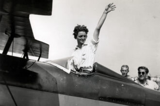 Louise Thaden, waving aboard an aircraft