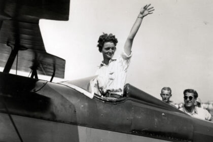 Louise Thaden, waving aboard an aircraft