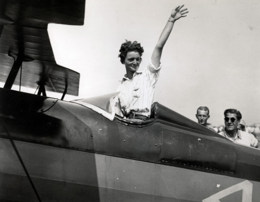 Louise Thaden, waving aboard an aircraft