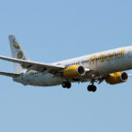 A yellow and white Flybondi aircraft coming in for landing.