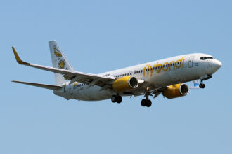 A yellow and white Flybondi aircraft coming in for landing.