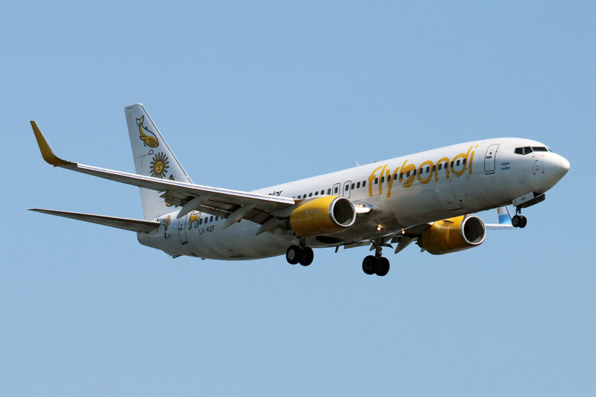 A yellow and white Flybondi aircraft coming in for landing.