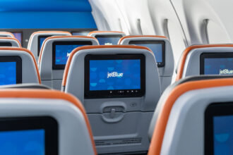 JetBlue seatback screens showing the airline’s logo, highlighting JetBlue free Wi-Fi and in-flight connectivity services.