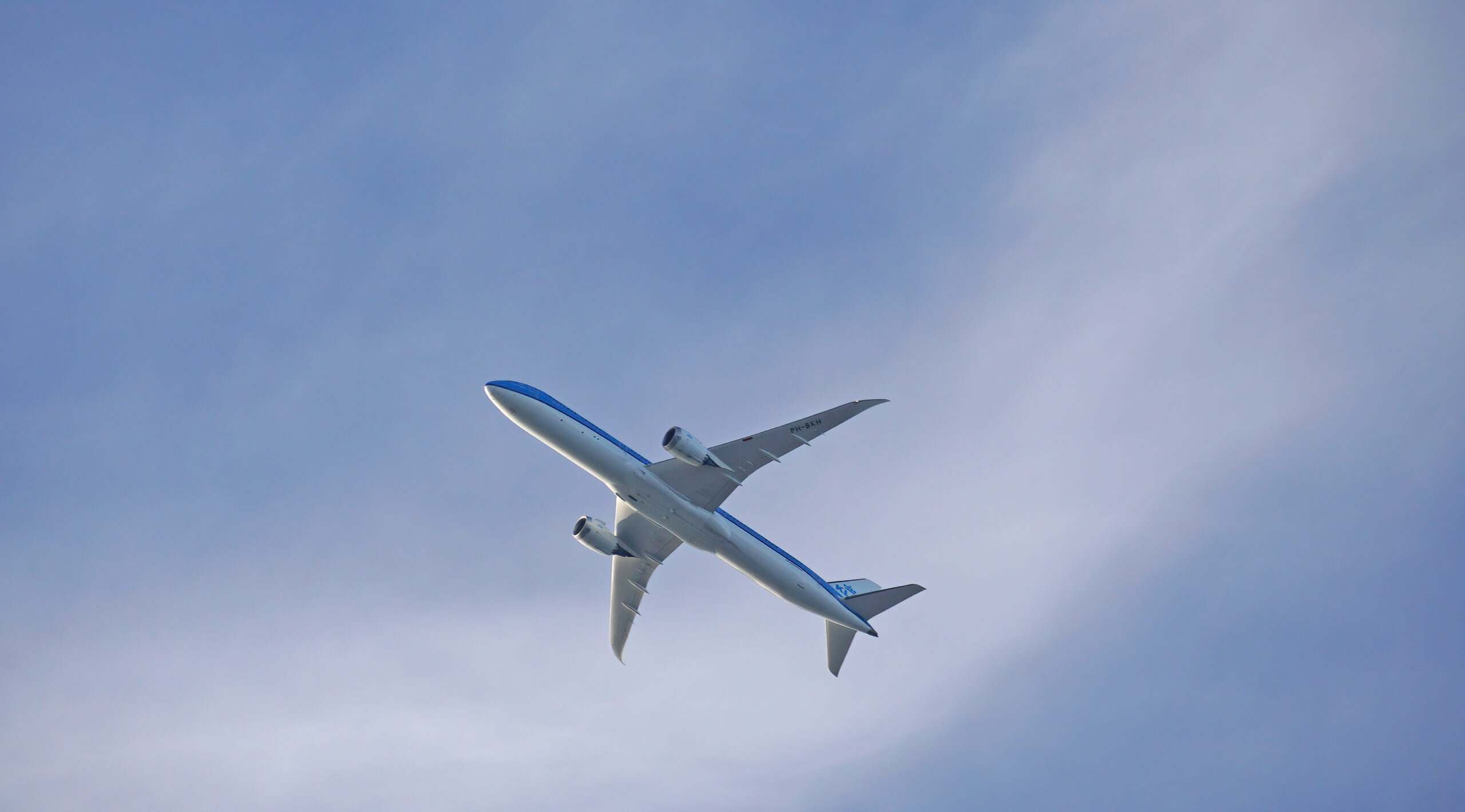 A view from below a KLM aircraft as it takes off.