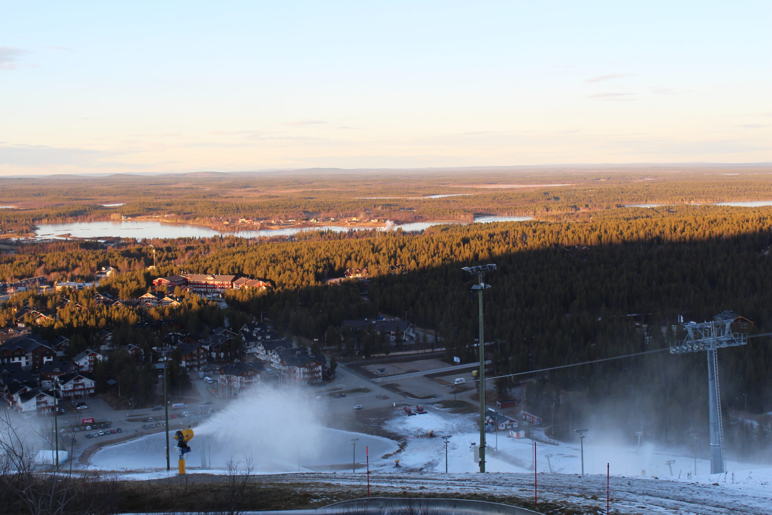 A view of Kittilä from a cable car, with snow and fir trees covering the landscape.