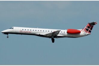 A Loganair flight, with its iconic tartan tail, takes off from Manchester airport.