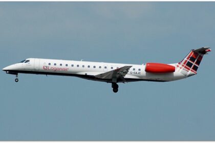 A Loganair flight, with its iconic tartan tail, takes off from Manchester airport.