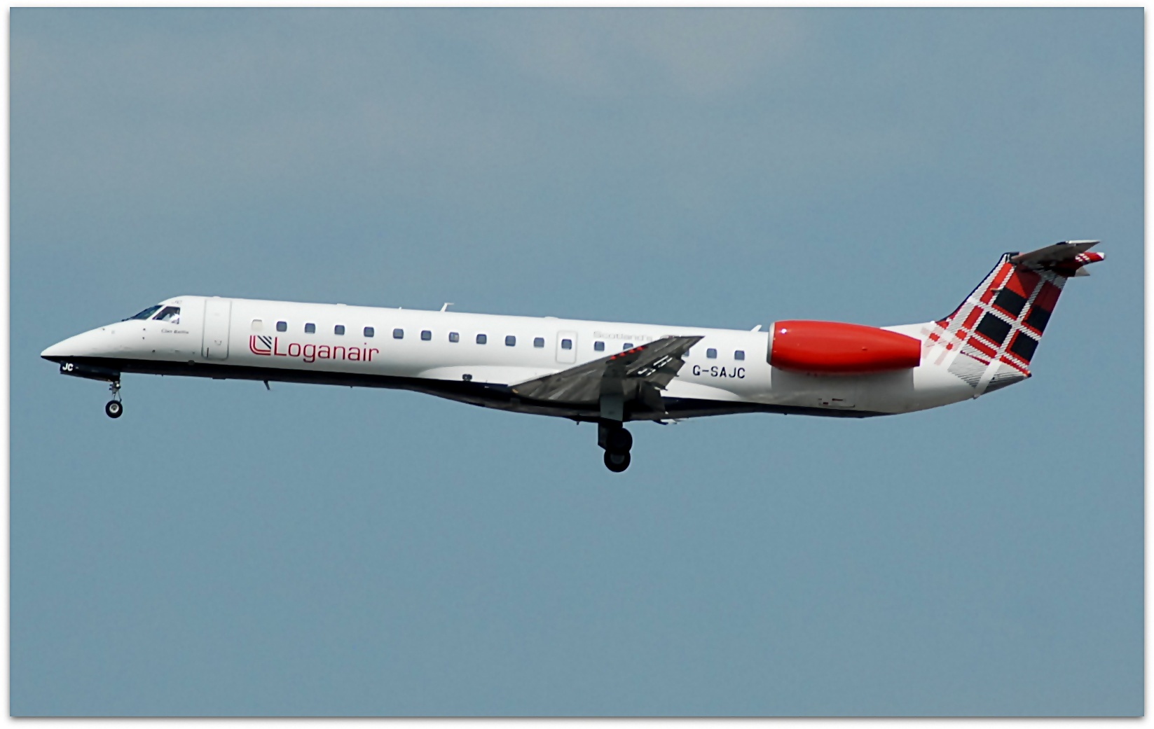 A Loganair flight, with its iconic tartan tail, takes off from Manchester airport.