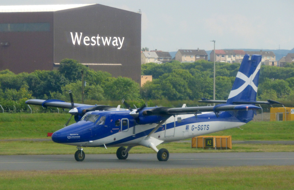 A Loganair plane with Scottish flag livery touches down at Glasgow airport.