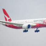 A Qantas plane coming in for landing which is decorated in a special livery for the airline's 100th anniversary.