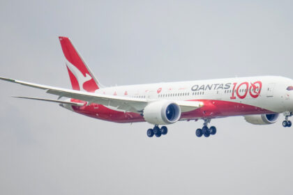 A Qantas plane coming in for landing which is decorated in a special livery for the airline's 100th anniversary.