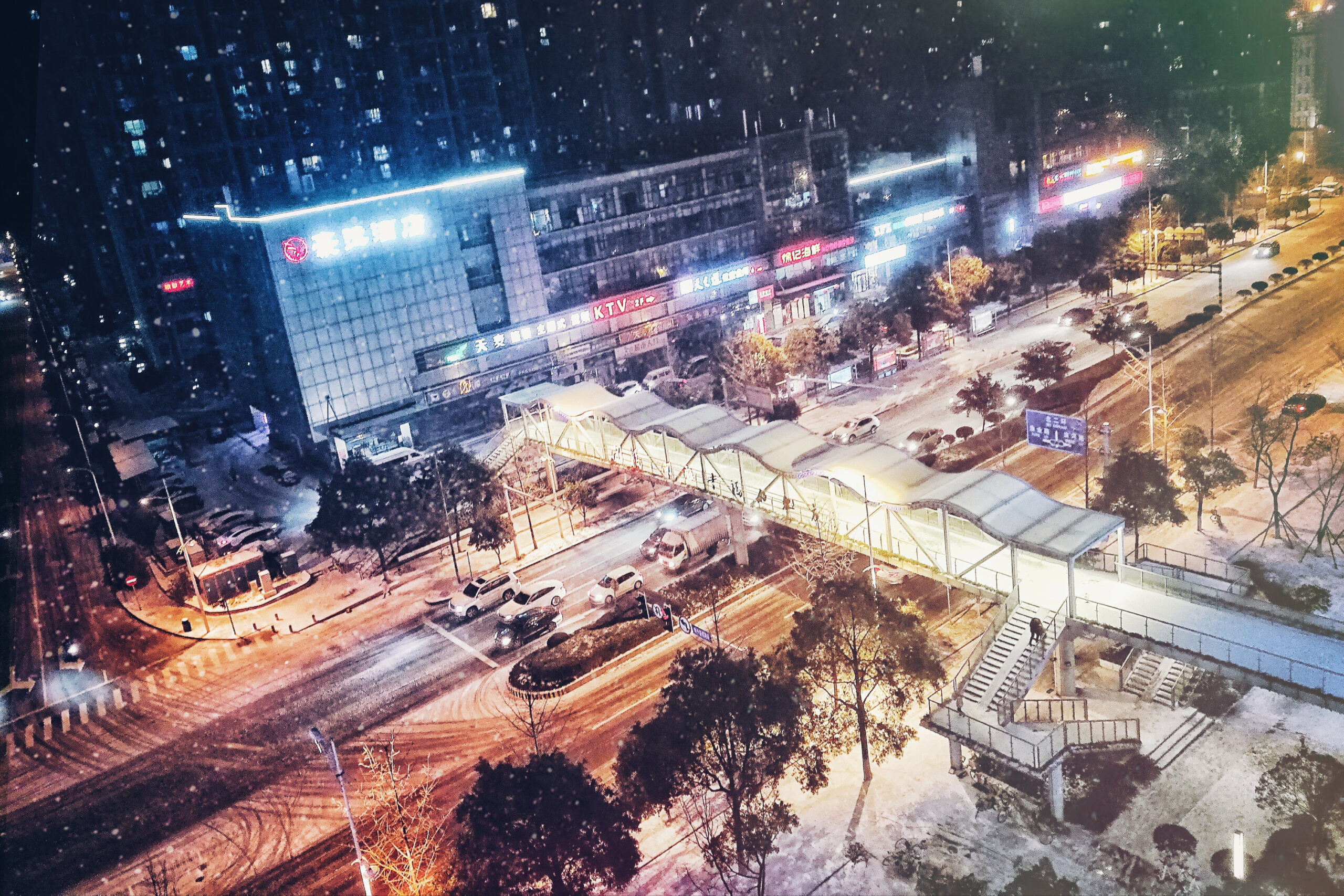 Snow falls at night on a busy street in Changsha, China.