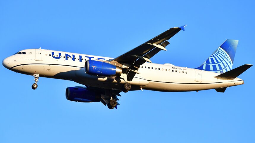 A United airlines plane in the blue sky.