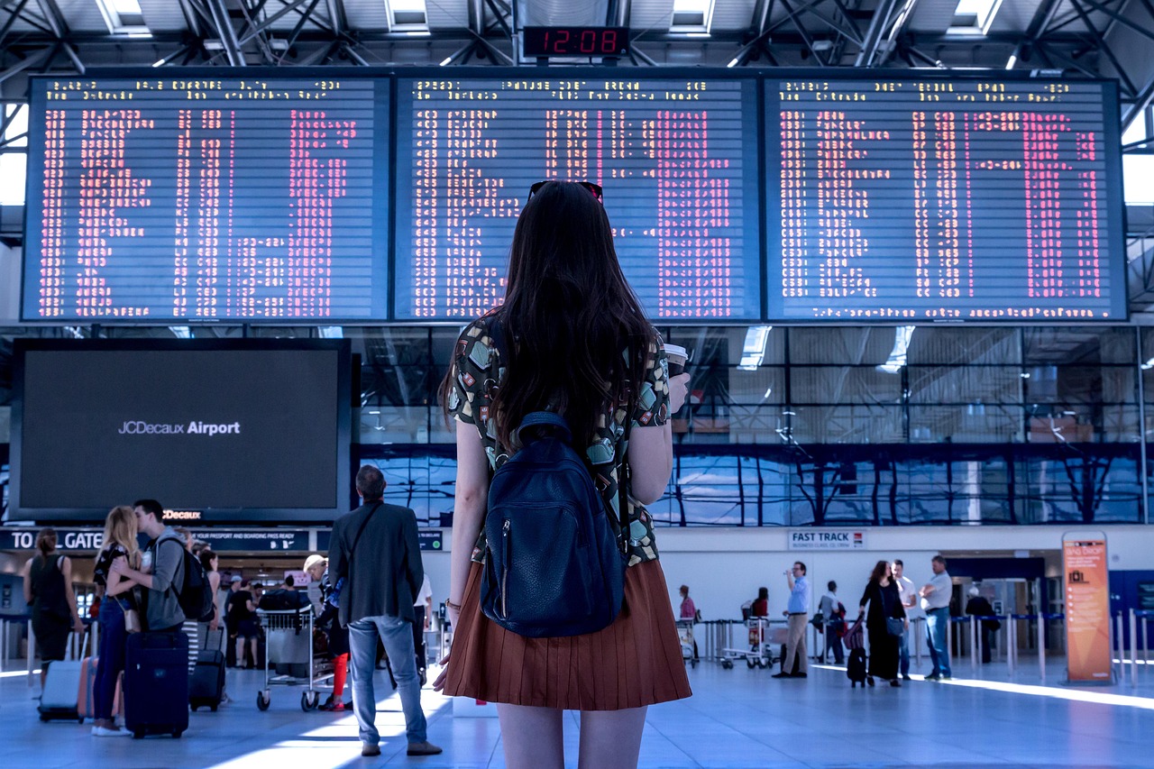Traveller checking departure board at airport 