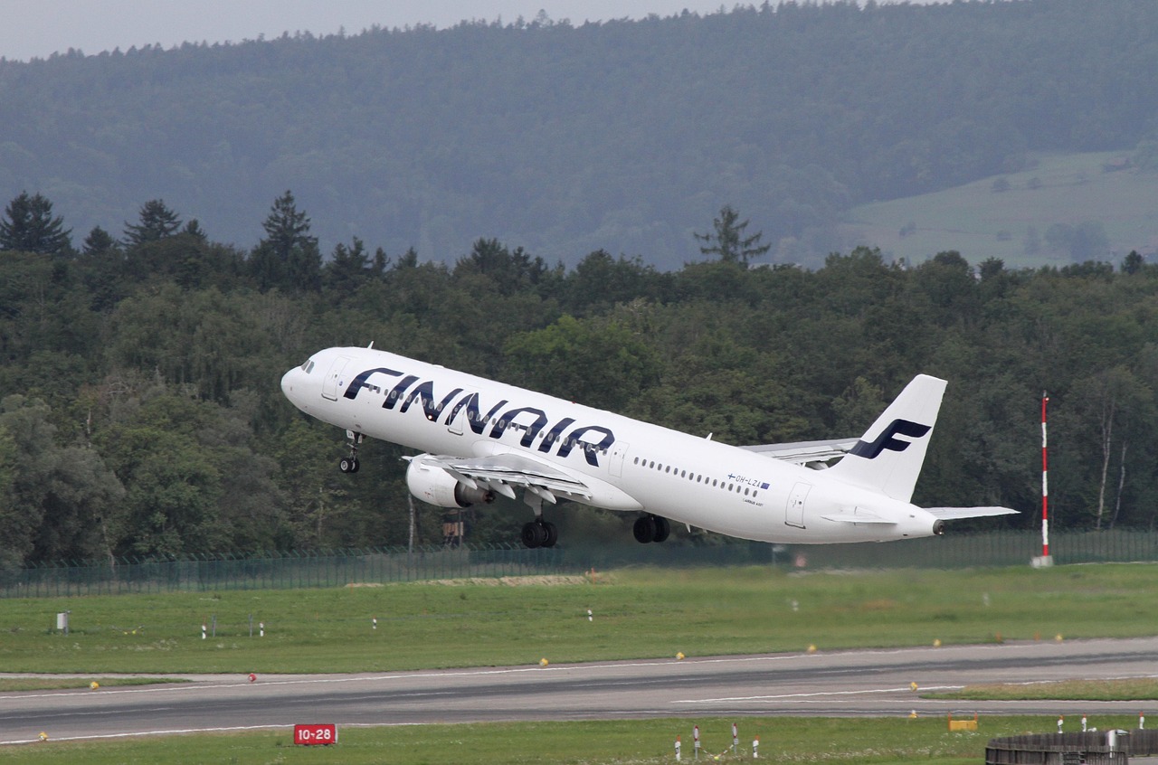 Finnair Airbus aircraft taking off from the runway, highlighting Finnair’s ancillary bundles and Sustainable Aviation Fuel investment strategy in 2025.