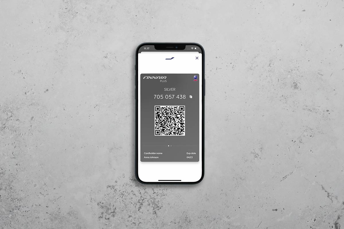 Finnair Plus digital membership card displayed on a smartphone, reflecting Finnair retail innovation 2025 with ancillary bundles and personalised services.