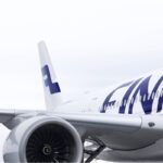 Finnair aircraft close-up showing engine, fuselage and tail logo, reflecting Finnair ancillary bundles and Sustainable Aviation Fuel investment strategy.