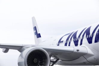 Finnair aircraft close-up showing engine, fuselage and tail logo, reflecting Finnair ancillary bundles and Sustainable Aviation Fuel investment strategy.