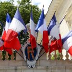 French flags hanging from a balcony
