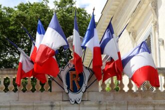 French flags hanging from a balcony