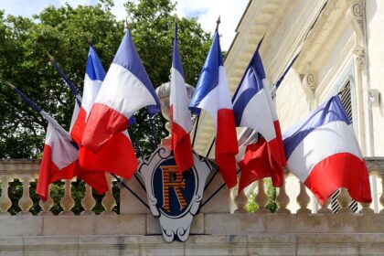 French flags hanging from a balcony