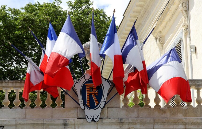 French flags hanging from a balcony