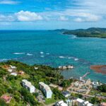 Aerial View of Coastal Town with Lush Greenery in Dominica