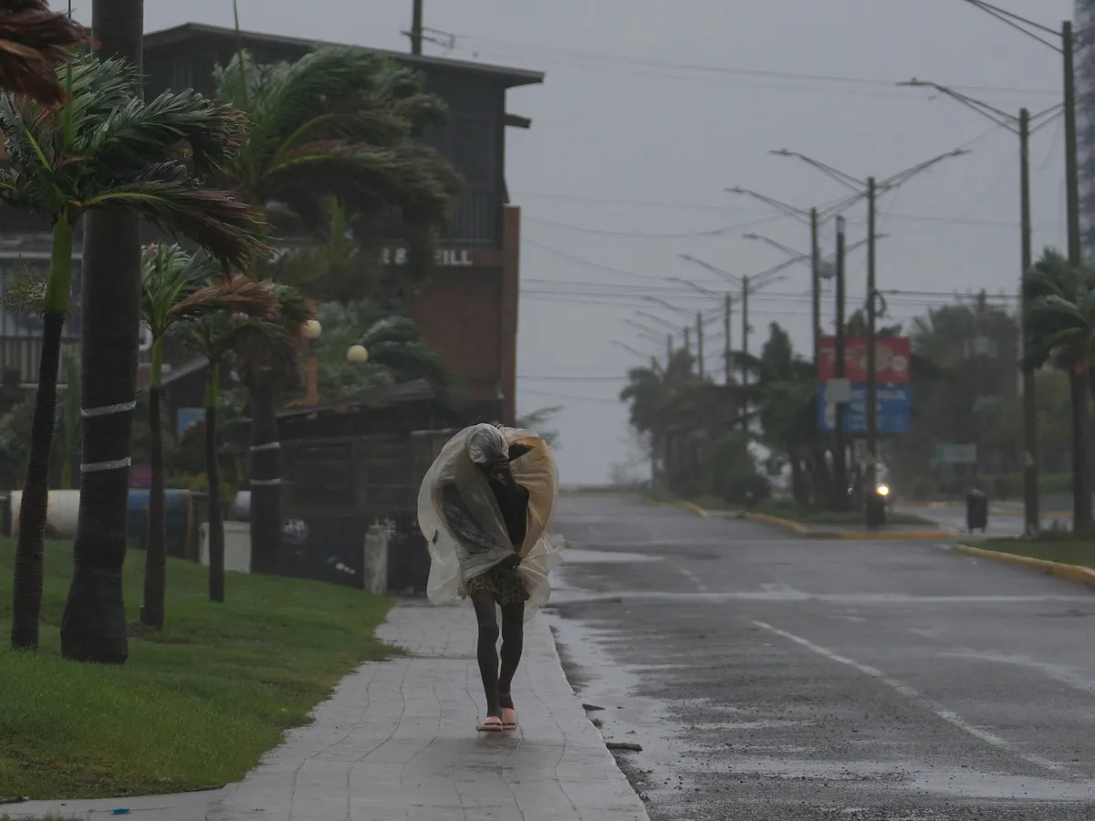 Man walking in Kingston Jamaica as Hurricane Melissa approaches 