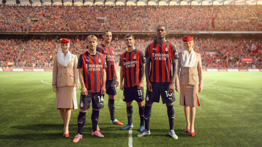Representatives from AC Milan wearing the sponsored jersey, with two Emirates flight attendants.