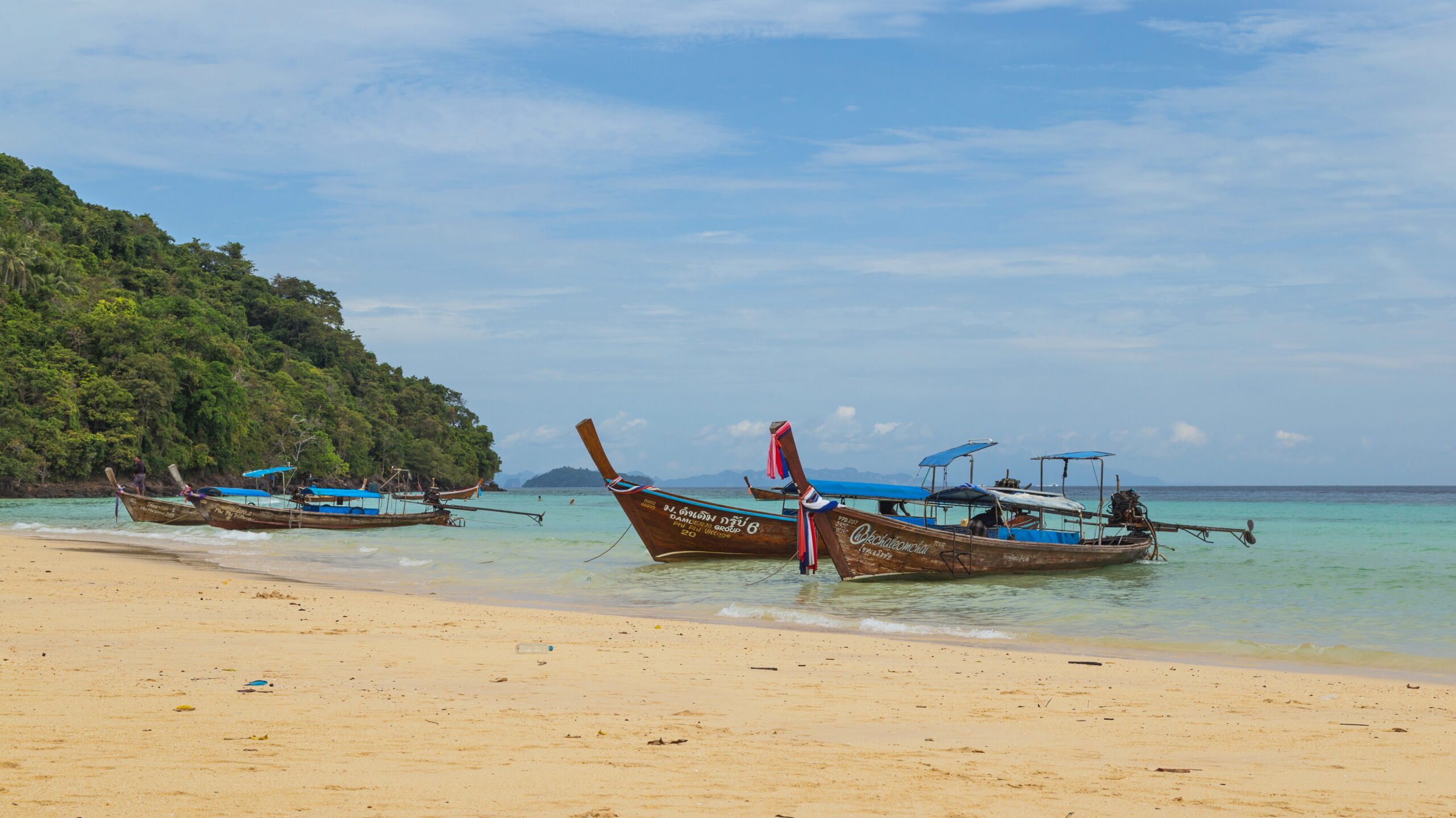 A boat docked at the beach on Ko Phi Phi island in Thailand.