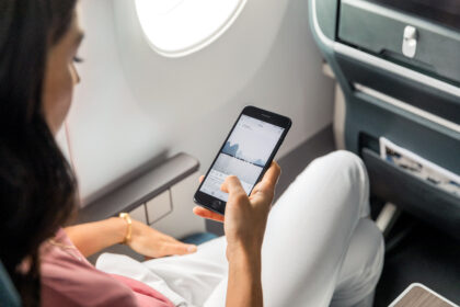 A woman scrolling on social media on a Cathay Pacific flight.