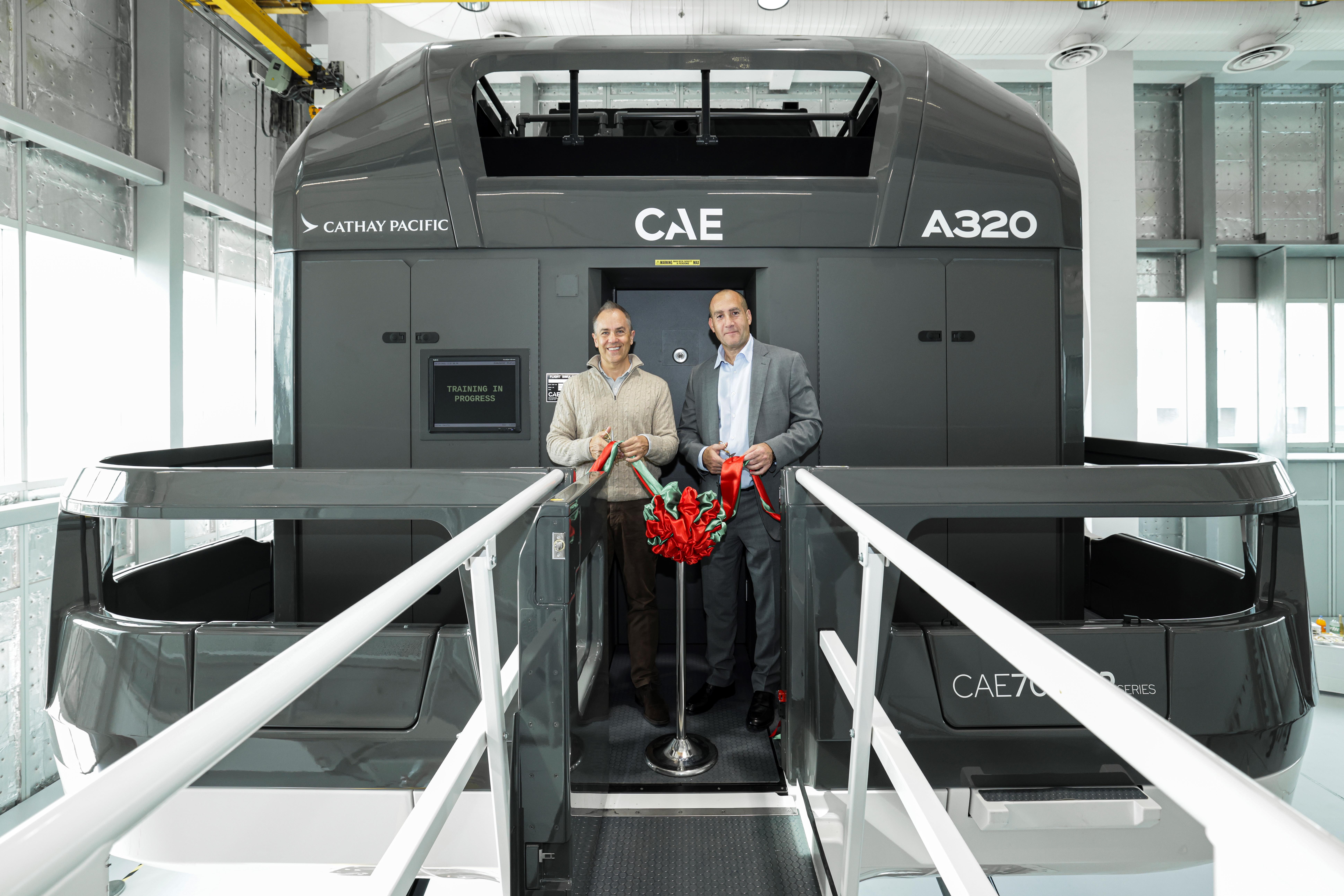 Cathay Chief Operations and Service Delivery Officer Alex McGowan (left) and CAE Division President, Commercial Aviation Michel Azar-Hmouda (right) unveil the new CAE Airbus A320neo full flight simulator.