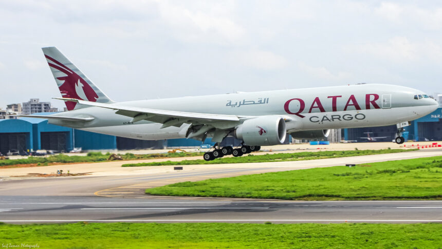 A Qatar Airways cargo plane coming in for landing on the runway.