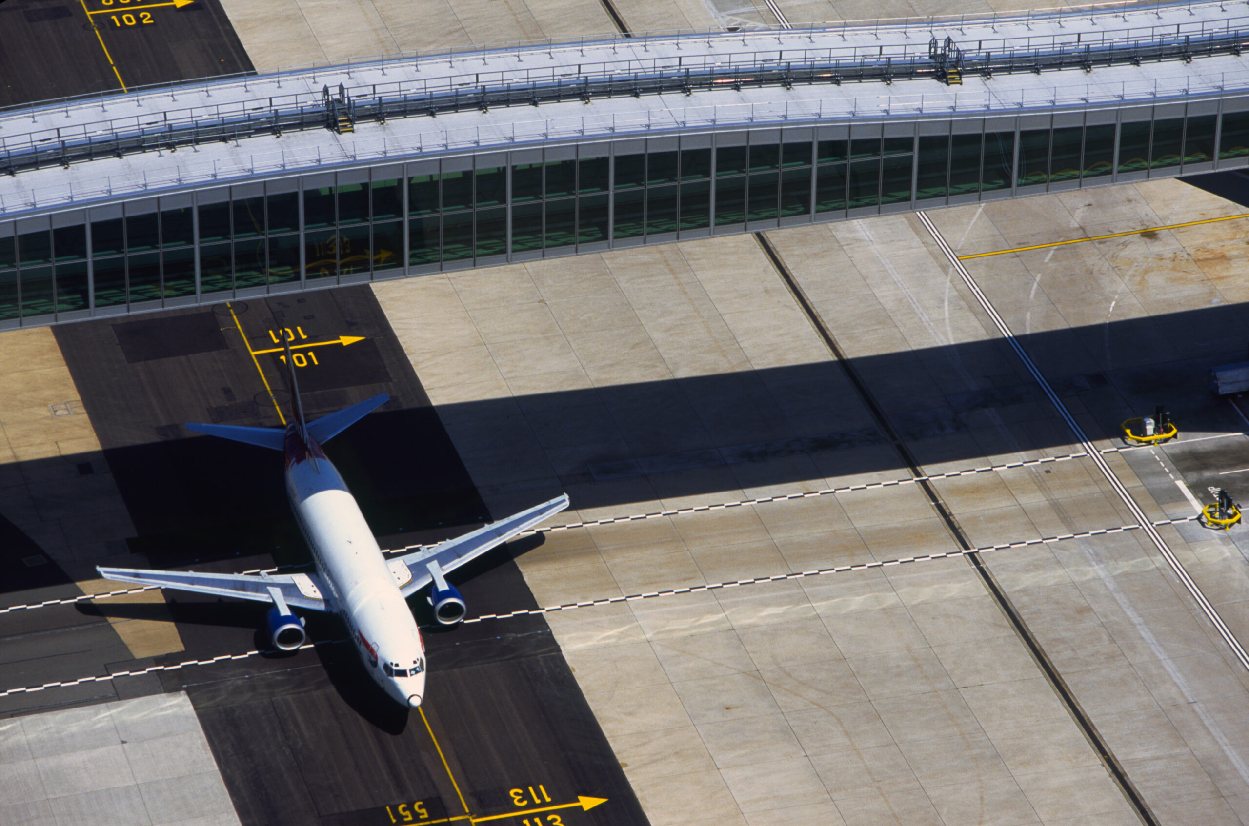 Aircraft passing under the bridge at Pier 6 at Gatwick AIrport