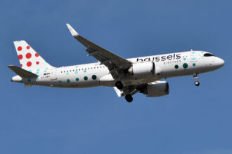 A Brussels Airlines plane flying in a blue sky.