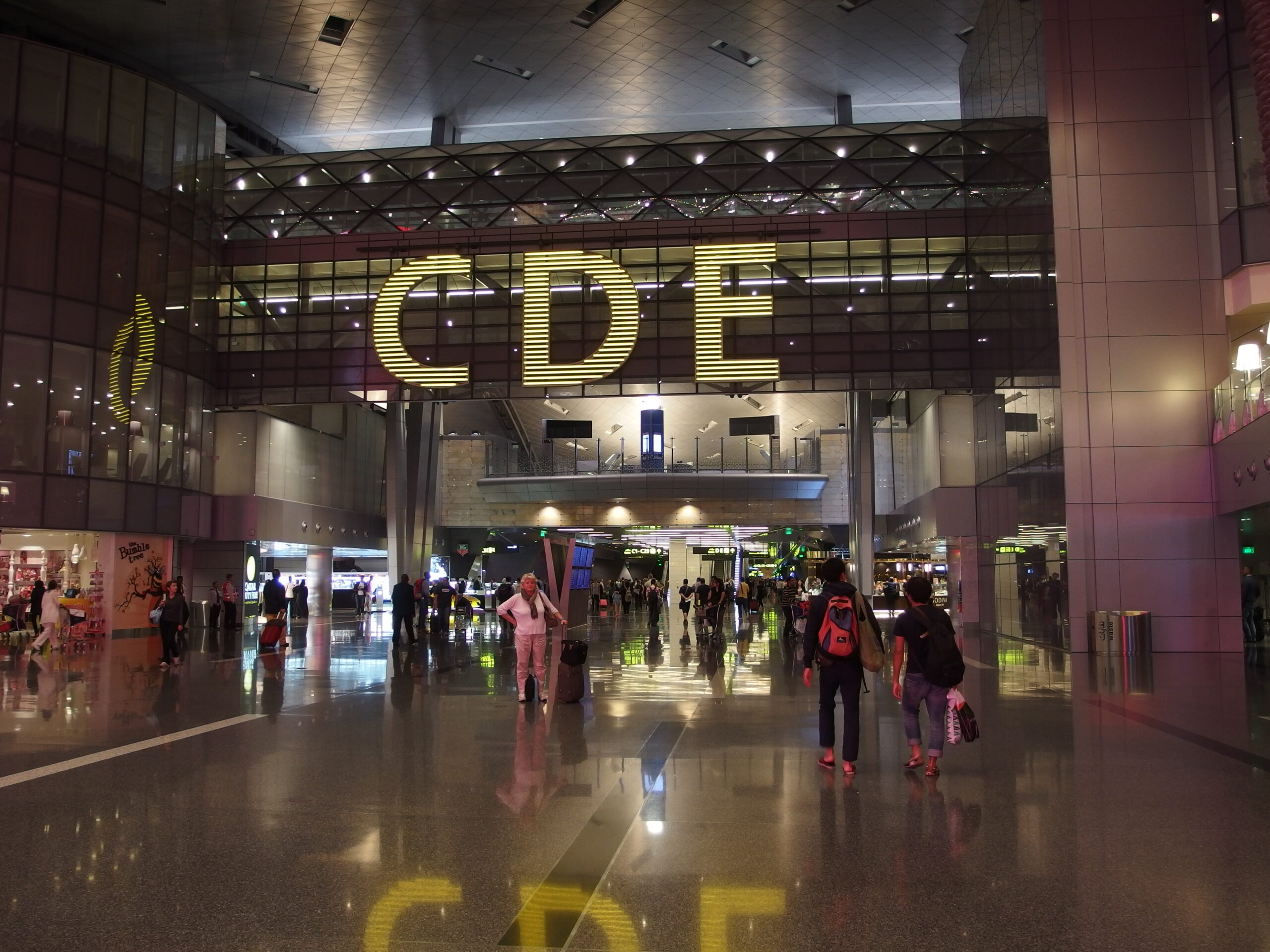 The well-lit entrance to gates C, D, and E at Hamad airport in Qatar.