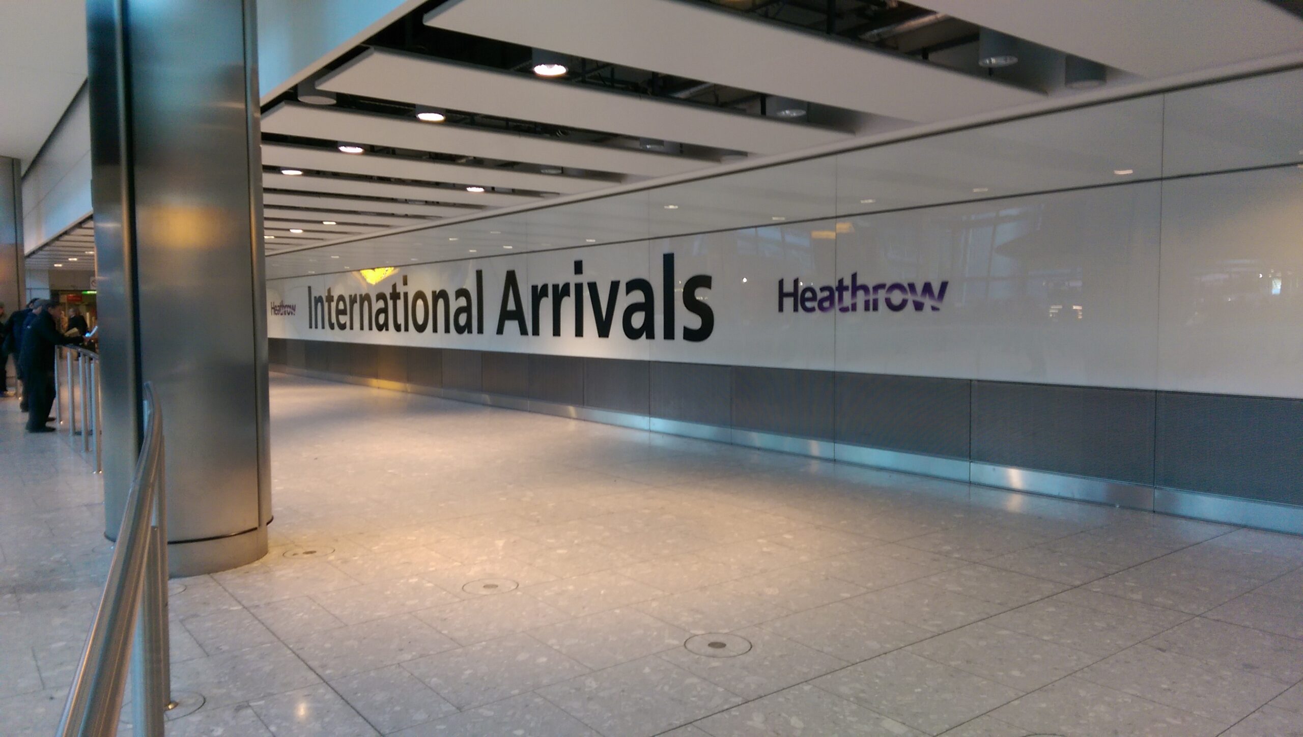The sign for International Arrivals at Heathrow Airport.